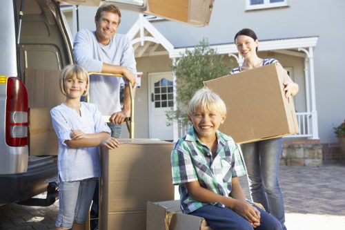 Professional mover transporting items through a Kensington street