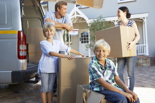 Loading furniture into a van on a busy Kensington street