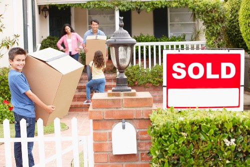 Organised house removal process in Kensington with boxes and wrapped furniture